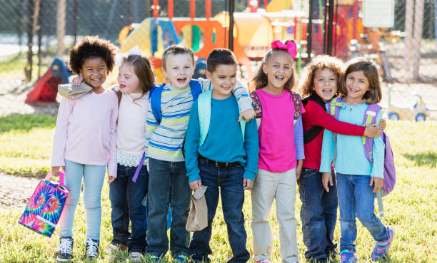 istock Multi-ethnic group of school children standing in a row 950960688