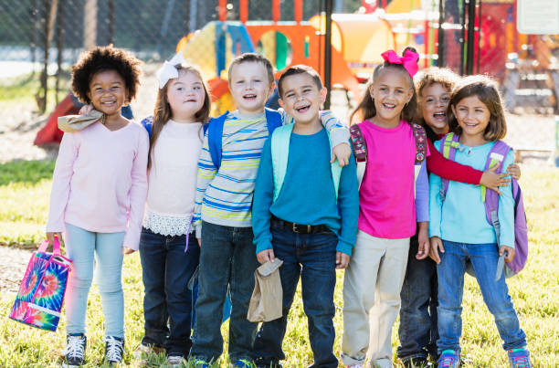 istock Multi-ethnic group of school children standing in a row 950960692