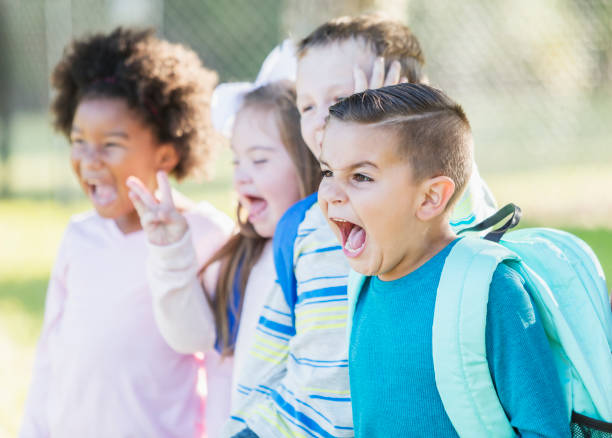 istock Boy with friends outdoors at school shouting 950961014