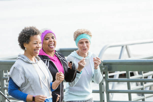 istock Three mature women jogging or power walking together 950961558