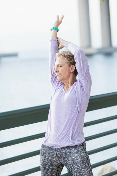 istock Senior woman exercising on city waterfront 950962020