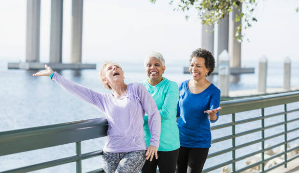 istock Three mature and senior women exercising on waterfront 950962022