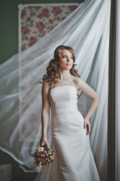 istock The girl with a bouquet at a developing curtain 2679. 950962418