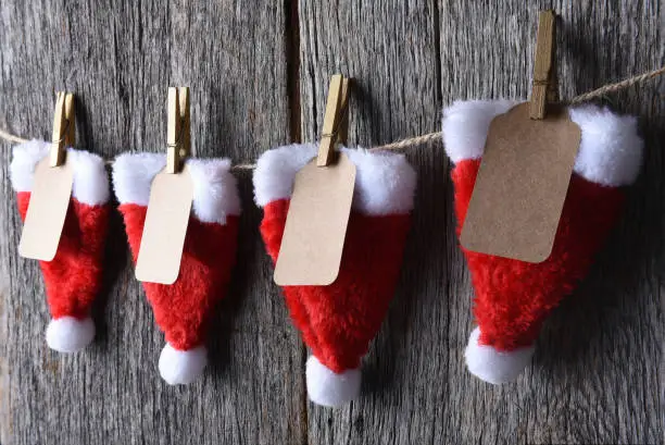 Advent Calendar made of Santa hats clothes pins and string.