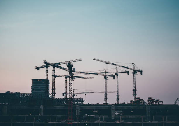 istock Silhouette construction  site over blurred background sunset pastel for industry background with Light fair.Grain Effects 950969888
