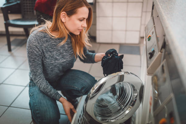 istock Woman with a laundry basket washing clothes 950970916
