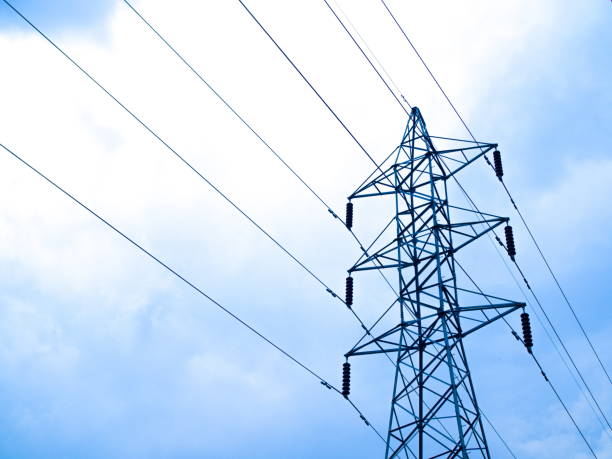 istock High voltage lines and power pylons with clound in the blue sky 950978788