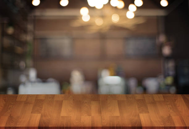 istock Wooden board empty table  cafe, coffee shop, bar blurred background can be used for display or montage your products and Mock up 950982004