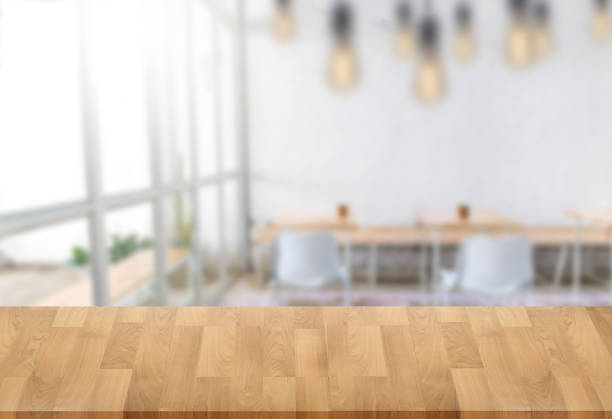 istock Wooden board empty table  window blurred background can be used for display or montage your products and Mock up 950982154