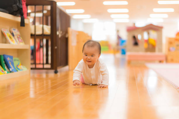 Relaxing Asian baby boy sit relax lying down and enjoy to using maker color drawing picture on drawing paper at home Little boy drawing on the floor
