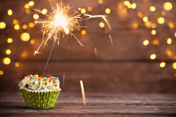 istock cupcake with sparkler on old wooden background 950987638
