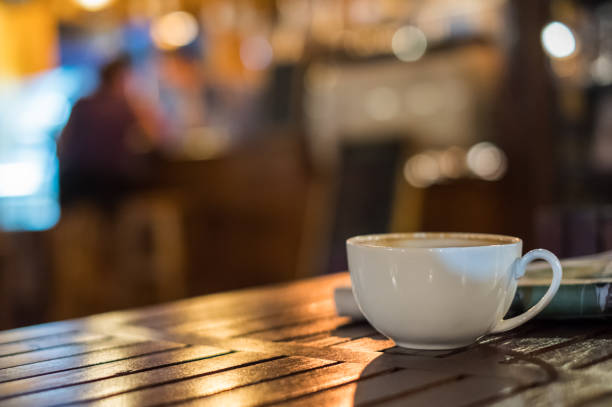 istock Hot Latte coffee cup on wooden table and glowing bokeh blur background 951001758
