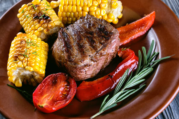 istock Piece of baked meat with vegetables and marinated on plate 951001978