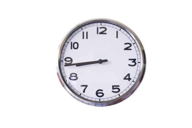 istock black and white stainless steel clock wall isolate on white background, in late morning time 951004992