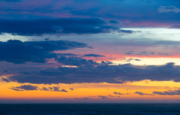 istock Colourful sunset with clouds and sunbeams 951005890