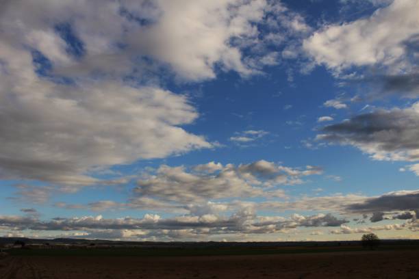 istock Landscape with cloudy sky and farm field in Castilla La Mancha 951006018
