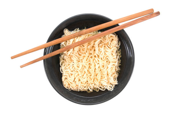 istock Noodles in black bowl with chopsticks isolated on white background 951006618