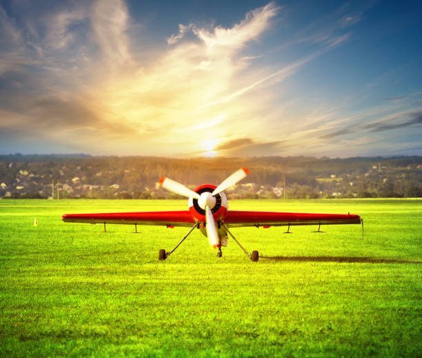 istock Red white airplane on the airfield at sunset 951007524