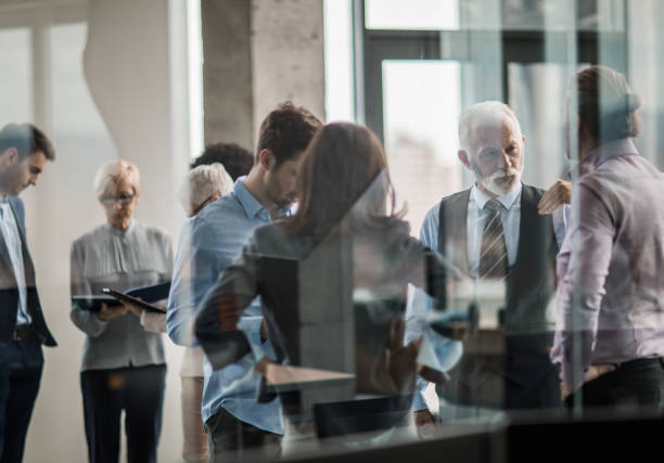 istock Large group of business colleagues working in a hallway. 951007628