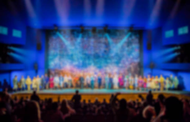 Defocused image. Auditorium in the theater during the performance. The scenery on the stage.