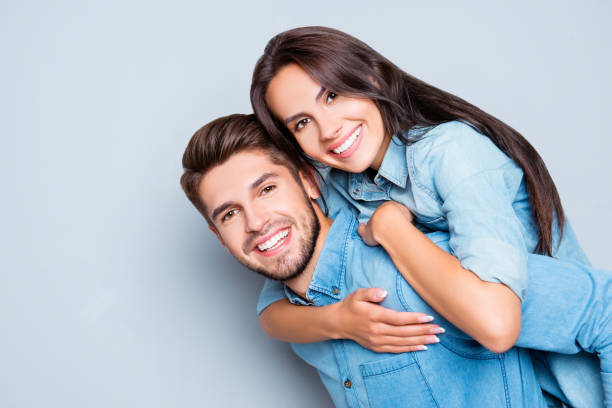 istock Happy cheerful man carrying his girlfriend on the back 951014248