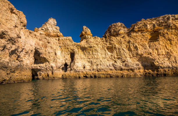 istock Lagos Caves and Seashore with its Esmerald Water 951014440
