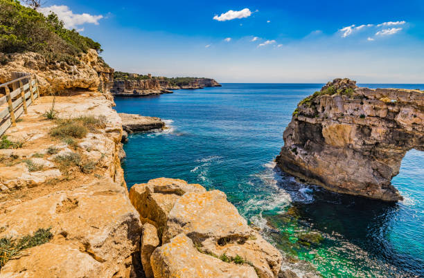 istock Spain Majorca, coastline cliffs with rock arch Es Pontas 951017428