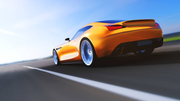 istock orange car driving on a road 951021900