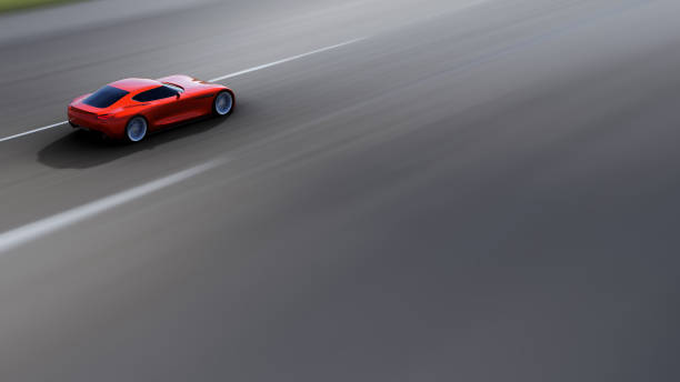 istock red car driving on a road 951022066