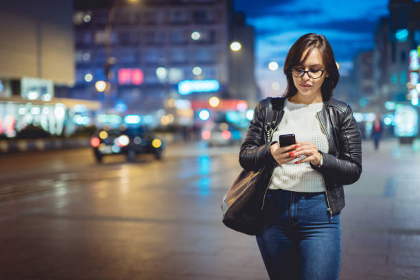 istock Woman texting outside at night 951026576
