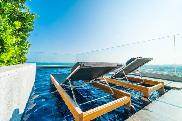 istock Chair and bed around swimming pool in hotel 951029308