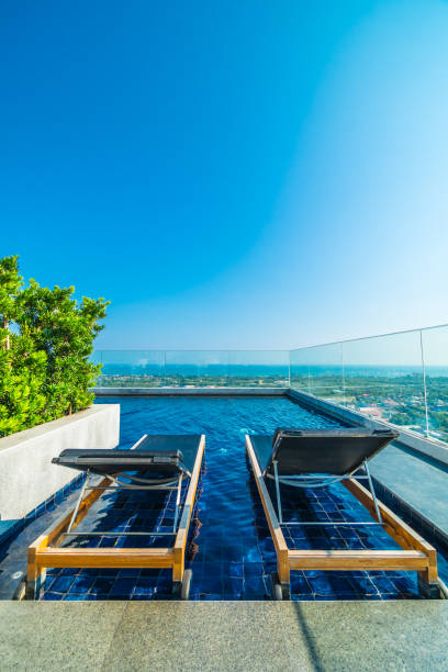 istock Chair and bed around swimming pool in hotel 951029366