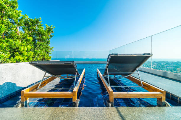 istock Chair and bed around swimming pool in hotel 951029442