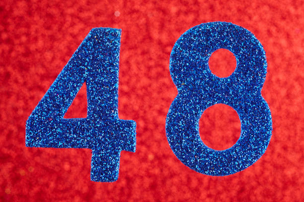 istock Number forty-eight blue color over a red background. Anniversary. Horizontal 951029448