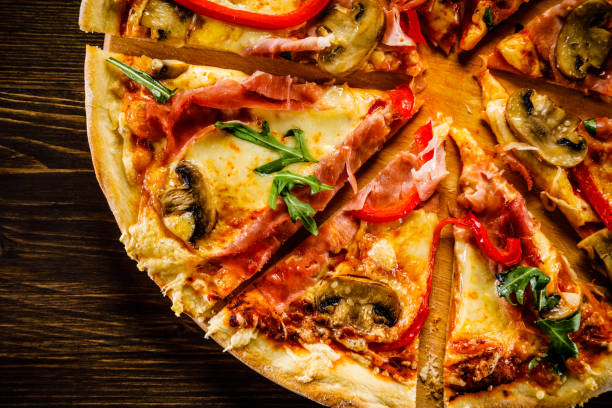 istock Pizza margherita with arugula on wooden background 951033222
