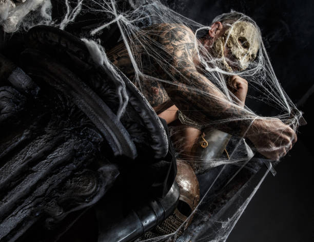 istock Muscular man with skull on his face. 951033440