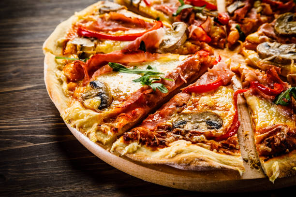 istock Pizza margherita with arugula on wooden background 951033458