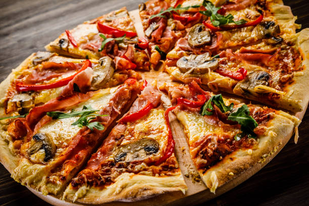 istock Pizza margherita with arugula on wooden background 951033486