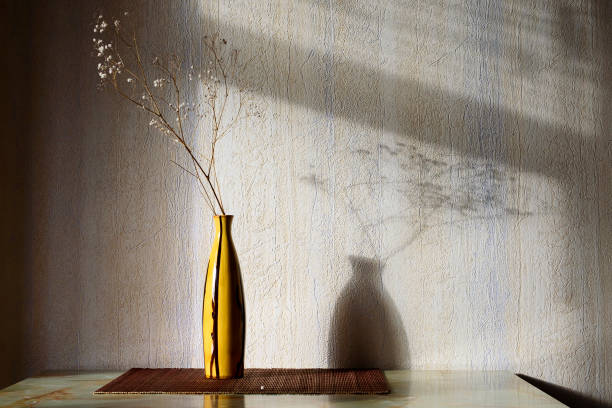 istock vase with a dry branch on the wall 951033548