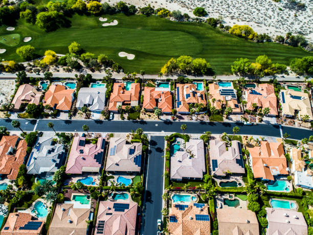 A row of houses with golf courses and pools. There is a pool next to the golf course and it is lining up. sod roof stock pictures, royalty-free photos & images