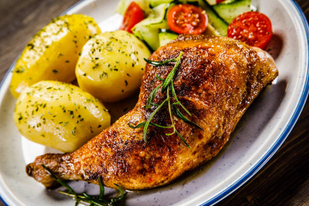 istock Roast chicken leg with boiled potatoes and vegetable salad 951038162