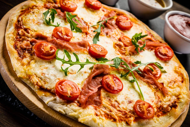 istock Pizza margherita with arugula on wooden background 951038358