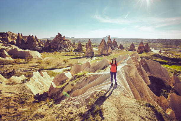 istock Traveler woman raised hands discovering mountains  with backpack. 951041348