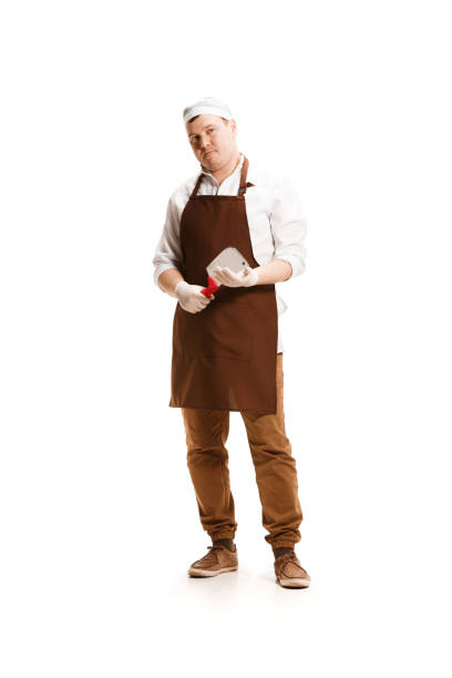 istock Smiling butcher posing with a cleaver isolated on white background 951042016