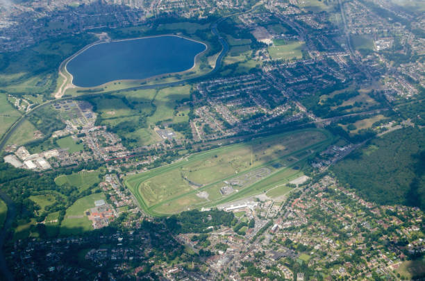 Esher and Sandown Park - aerial view Aerial view of Esher in Surrey with the Sandown Park race course in full view plus the Island Barn Reservoir and the River Mole. Sunny summer day. esher stock pictures, royalty-free photos & images
