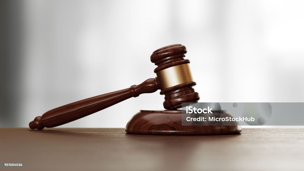 Wooden Gavel Over Defocused Background Wooden gavel over defocused background. Front view with selective focus. Great use for law, justice and auction related concepts. Gavel Stock Photo