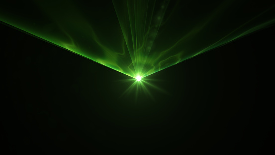 Green laser light on black background. Horizontal composition.