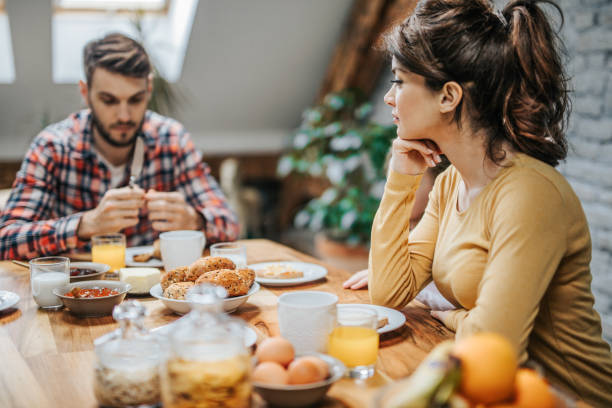 istock Young pensive woman during breakfast with her family. 951054470