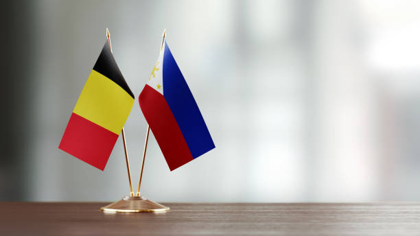 istock Belgian And Philippines Flag Pair On A Desk Over Defocused Background 951054686