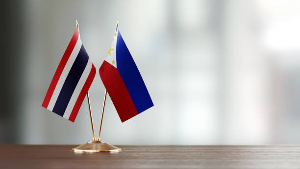 istock Thai And Philippines Flag Pair On A Desk Over Defocused Background 951054834